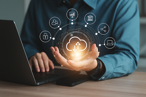 Person holding a glowing cloud icon above a laptop, surrounded by digital icons representing cloud computing services.
